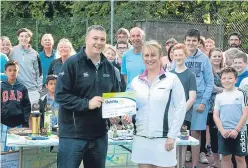  ??  ?? Mr Kavanagh presents the award to the club’s Liz McCubbin.