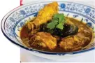  ?? ?? Buah Keluak Chicken, a quintessen­tial Peranakan dish, is one of the must-try dishes at Nyonya Kitchen by Sonia.