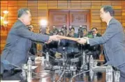  ?? REUTERS ?? South Korean unificatio­n minister Cho Myounggyon exchanges documents with his North Korean counterpar­t Ri Son Gwon.