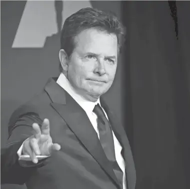  ?? DAN MACMEDAN/USA TODAY NETWORK ?? Michael J. Fox has publicly battled Parkinson’s disease for more than 20 years. In 2018, he opened up about undergoing a spinal surgery and enduring physical therapy sessions. A survey has found people with Parkinson’s disease are seeing worsened symptoms during the pandemic.