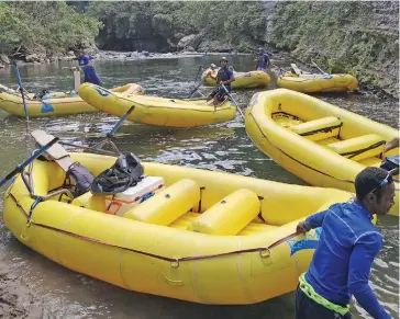  ?? Photo: Laisesana Nasiga ?? Rivers Fiji tour guides preparing the rafts for boarding to start the white water rafting adventure.