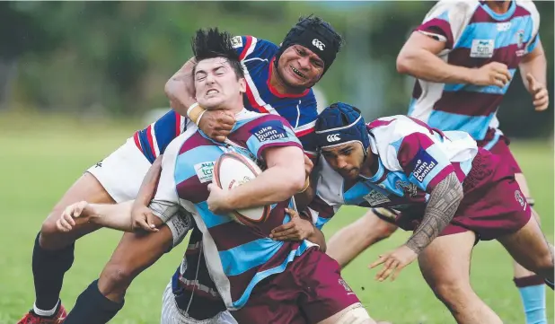  ?? Picture: BRENDAN RADKE ?? COLLARED: JCU's Liam Duncan is tackled by Barron Trinity's Alphonse Gima during their thrilling FNQ Rugby draw at the weekend.