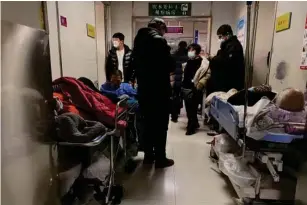  ?? (AFP via Getty) ?? Covid - 19 patients on a tro ll ey at Tianjin First Center Hospital