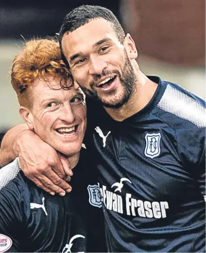  ?? Picture: SNS. ?? Dark Blues new boys Simon Murray and Steven Caulker celebrate Dundee’s vital victory over Partick Thistle at Firhill – but is a top six place beyond Neil Mccann’s side’s reach?