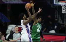  ?? MATT SLOCUM - THE ASSOCIATED PRESS ?? 76ers center Joel Embiid, left, goes up for a shot against Boston’s Robert Williams III Tuesday in a preseason win over the Celtics. Embiid was not available Friday night for the Sixers’ second and final preseason game, a win over Indiana.