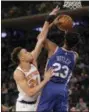  ?? SETH WENIG — THE ASSOCIATED PRESS ?? New York Knicks’ Kevin Knox, left, defends Philadelph­ia 76ers’ Jimmy Butler during the first half of Sunday’s game in New York.