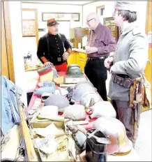  ?? Lynn Atkins/The Weekly Vista ?? Carlos Valdez (left), dressed in a French uniform, brought some of his collection of World War I Memberilia to the Bella Vista Historical Museum where the annual meeting included a talk about the start of the war, 100 years ago next month. Docent Tim...