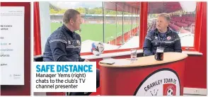  ??  ?? SAFE DISTANCE Manager Yems (right) chats to the club’s TV channel presenter