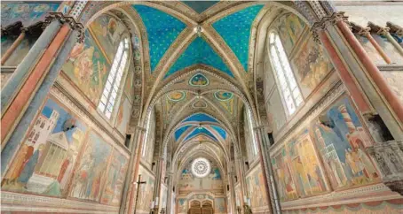  ?? DOMINIC ARIZONA BONUCCELLI ?? Assisi’s Basilica of St. Francis, colorfully frescoed by the Florentine artist Giotto, inspires tourists and pilgrims today.