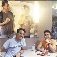  ??  ?? Fil-Ams Jevh Maravilla and Christian Toledo noticed there was a blank wall at a McDonald’s in Pearland, Texas so they decided to make a fake poster of themselves and put it up.