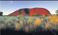  ??  ?? The sun sets on Uluru, about 350km south west of the central Australian town of Alice Springs. Climbing on the sacred rock will be banned starting next month.