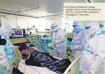  ?? AP ?? Principal of Medical College speaks with a Covid-19 patient at the ICU ward of SRN Hospital in Prayagraj on Saturday.