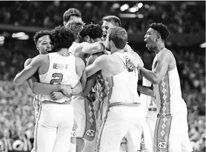  ?? BOB DONNAN, USA TODAY SPORTS ?? North Carolina players celebrate Monday after defeating Gonzaga for the college basketball championsh­ip. “This group was tough enough,” coach Roy Williams said.