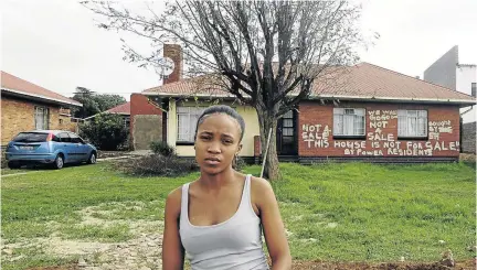  ?? /THULANI MBELE ?? Wandile Makoko, 21, in front of her family home in Power Park, Soweto, which was allegedly sold by her uncle without the family's consent.