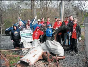  ?? MEDIANEWS GROUP FILE PHOTO ?? Participan­ts in a previous stream cleanup hosted by the Perkiomen Watershed Conservanc­y stand behind the items they pulled from along the banks of the stream.