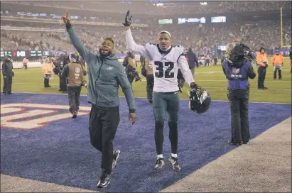  ?? SETH WENIG - THE ASSOCIATED PRESS ?? Eagles cornerback Rasul Douglas, right, waves to the fans after a Dec. 29 game against the New York Giants. The Eagles waved goodbye to the 2017 third-round draft pick Saturday as part of cuts to arrive at a 53-man roster.