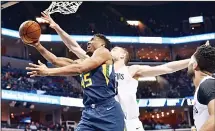  ?? (AP) ?? Utah Jazz guard Donovan Mitchell (45) shoots against Memphis Grizzlies center Marc Gasol (center right), during the second half of an NBA basketball game on Feb 7, in Memphis, Tennessee.