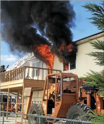  ?? GINGER RAE DUNBAR – DIGITAL FIRST MEDIA ?? Smoke and fire billows from living room windows during this week’s live-burn demonstrat­ion at the county Emergency Services Training Center in Darby Township. The program pushed the notion of closing bedroom doors before going to bed at night.