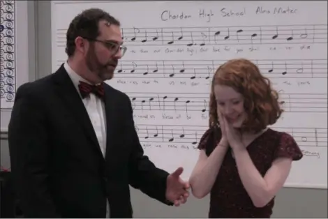  ?? KRISTI GARABRANDT — THE NEWS-HERALD ?? Katy Lessick, a senior at Chardon High School battling an malignant brain tumor, gets emotional when Chardon High School Choir Director Fritz Streiff presents her with a new keyboard, during the reveal of the newly updated choir room at Chardon High School which was made possible through the Make-A-Wish Foundation at Katy’s request.