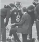  ?? SABAU/GETTY JAMIE ?? Trainers tend to Giants quarterbac­k Daniel Jones on Sunday in Cincinnati.