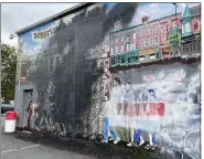  ?? EVAN BRANDT — MEDIANEWS GROUP ?? The stencil of the white nationalis­t group that was painted onto the defaced No Place for Hate mural has been covered up by more paint.