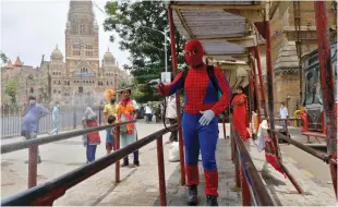  ?? (Niharika Kulkarni/Reuters) ?? A MAN DRESSED as Spiderman sanitizes a bus stop outside Chatrapati Shivaji Maharaj railway station during a COVID-19 lockdown in Mumbai two days ago.