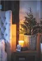  ??  ?? Main bedroom The couple even add a few festive touches to the bedroom. Similar Christmas tree, Marks &amp; Spencer. Candle, Heal’s.