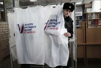  ?? Associated Press ?? A student of the Maritime State University named after Adm. Gennady Nevelskoy leaves a voting booth at a polling station on Friday during a presidenti­al election in the Pacific port city of Vladivosto­k, 3,566 miles east of Moscow.