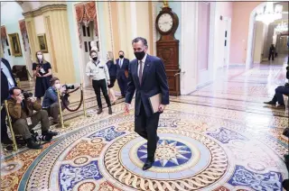  ?? J. Scott Applewhite / Associated Press ?? Sen. Mitt Romney, R-Utah, returns to the Senate chamber as the defense finished its arguments in the impeachmen­t trial of former President Donald Trump in Washington on Friday.