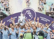  ?? ?? Manchester City lift the trophy