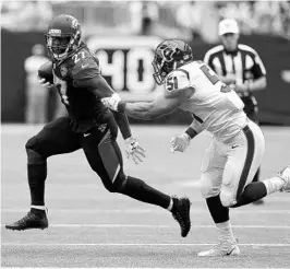  ?? BOB LEVEY/GETTY IMAGES ?? Jaguars rookie RB Leonard Fournette gets past Texans LB Dylan Cole in the 4th quarter on Sunday. Fournette became the 1st player to rush for at least 100 yards in his Jags’ debut.