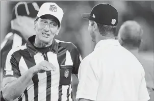  ?? Nick Wass/associated Press ?? Referee Gene Steratore talks with Ravens coach John Harbaugh before the game Thursday night between the Ravens and the Browns in Baltimore.