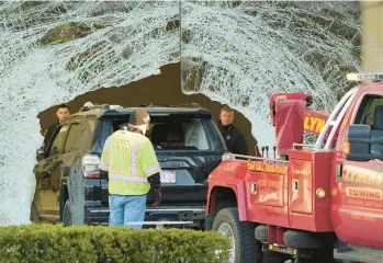  ?? STEVEN SENNE/AP ?? A worker uses a tow truck to remove an SUV from inside an Apple store Monday in Hingham, Mass. One person was killed and 16 others injured when the SUV crashed into the store, authoritie­s said. Plymouth District Attorney Timothy Cruz said a criminal investigat­ion was underway. The victim was identified as Kevin Bradley, 65, of New Jersey.