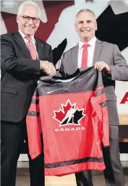  ?? JEFF MCINTOSH, CP ?? Hockey Canada president Tom Renney, left, congratula­tes Team Canada’s 2017-18 head coach, Willie Desjardins, at a news conference in Calgary Tuesday.