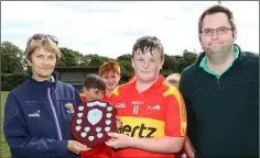  ??  ?? Horeswood captain William Foley with Angela McCormack (Coiste na nOg) and Dean Goodison, representi­ng People Newspapers.