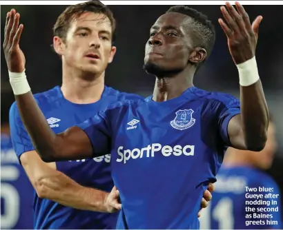  ??  ?? Two blue: Gueye after nodding in the second as Baines greets him
