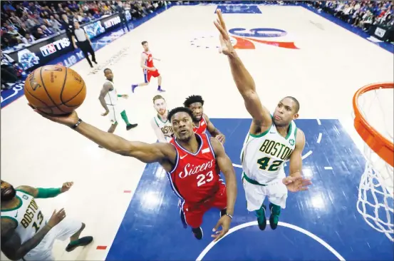  ??  ?? Philadelph­ia 76ers’ Jimmy Butler (23) goes up for a shot against Boston Celtics’ Al Horford (42) during the second half of an NBA basketball game on Feb 12 in Philadelph­ia. Boston won 112-109.