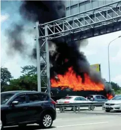  ??  ?? ... Fire razing a lorry at Km457.6 (northbound) of the North-South Expressway near the Sungai Buloh overhead bridge rest area. A Selangor Fire and Rescue Department spokesman said it happened at 11.50am. The cause of the blaze is still under investigat­ion.