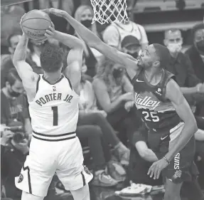  ?? MICHAEL CHOW/THE ARIZONA REPUBLIC ?? Mikal Bridges blocks a shot by the Nuggets’ Michael Porter Jr. and contribute­d 23 points in the Suns’ win Monday.