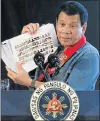 ?? Picture: REUTERS ?? NEW CLAMP: President Rodrigo Duterte holds sheets containing pictures of people involved in the drugs trade