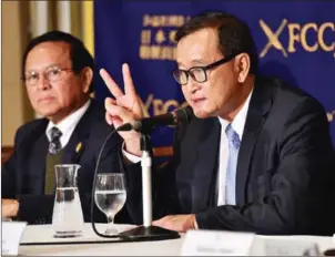  ?? YOSHIKAZU TSUNO/AFP ?? Then-Cambodia’s main opposition Cambodia National Rescue Party president Sam Rainsy (right) speaks to the press in Tokyo on November 10, 2015.