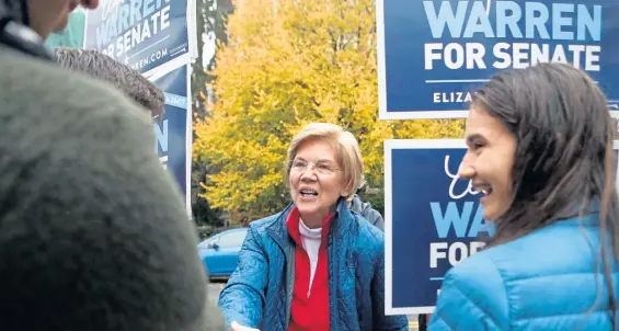  ?? NANCY LANE / BOSTON HERALD ?? CASTING CALL: Sen. Elizabeth Warren greets supporters on her way in to vote yesterday in Cambridge.