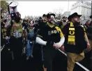  ??  ?? Trump supporters wearing attire associated with the Proud Boys attend Saturday’s rally.