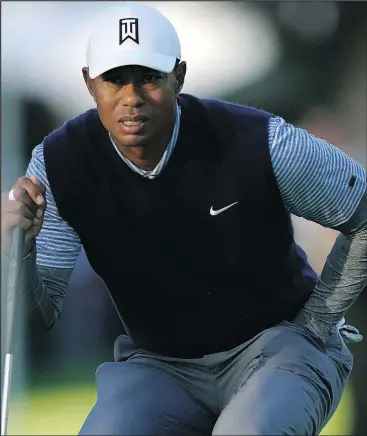  ?? — AP ?? Tiger Woods reads the green before putting on the 12th hole for birdie during the third round of the Genesis Open at the Riviera Country Club in Los Angeles Saturday.