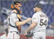 ?? LYNNE SLADKY — THE ASSOCIATED PRESS ?? Giants catcher Nick Hundley talks with relief pitcher Reyes Moronta during the ninth inning of Wednesday’s loss.