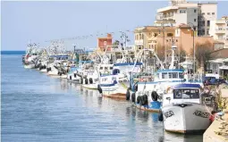  ?? ANDREW MEDICHINI/AP ?? Fishing boats are moored at port Friday in Fiumicino, Italy. Fishermen, squeezed by higher gas prices, stayed in port, mending nets instead of casting them.