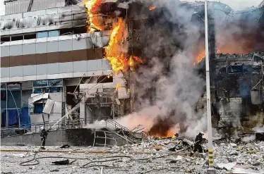  ?? Ukrainian Emergency Service/Associated Press ?? Firefighte­rs work at a building in Kyiv, Ukraine, after a Russian strike on Friday. A Ukrainian air force official said Russia’s attack across the country Friday was “the most massive aerial attack” of the war.