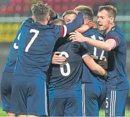  ??  ?? George Johnston (right) joins in the celebratio­ns after Allan Campbell had netted Scotland’s winner in Vilnius in midweek