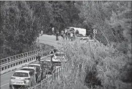  ?? [MANU FERNANDEZ/THE ASSOCIATED PRESS] ?? Police stand around a hearse at the site where the main suspect in the Barcelona attack was shot and killed Monday. The man was shot near Subirats, Spain.