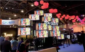  ?? LIA ZHU / CHINA DAILY ?? TCL’s new TV lineups featuring 4K high dynamic range picture performanc­e are on display at the CES 2018 in Las Vegas. Major Chinese TV makers have been competing for attention with high picture and sound quality during the show.